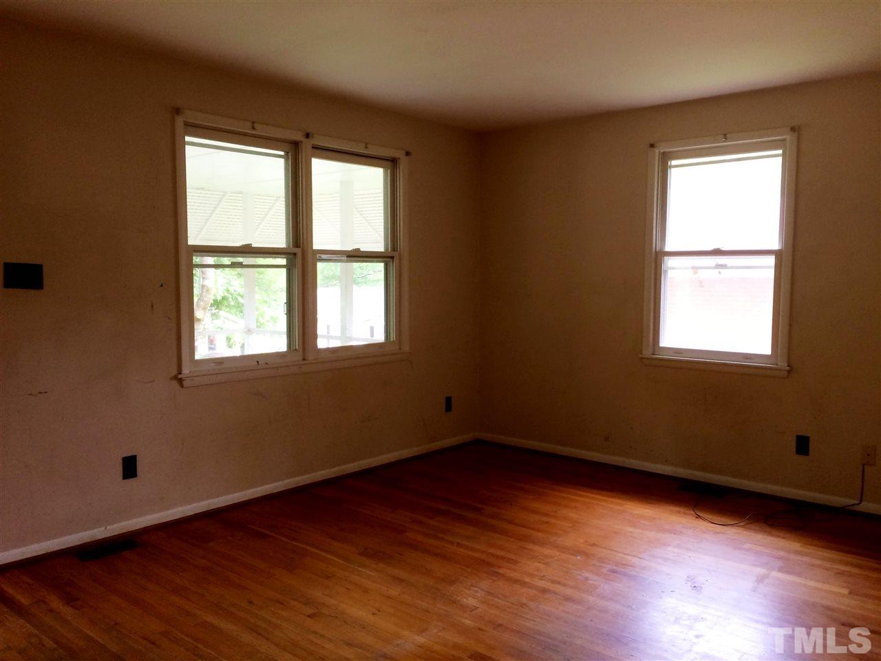 604 Latta Street Raleigh, NC 27607 - Photo 4 of 7 an empty room with wooden floor and windows