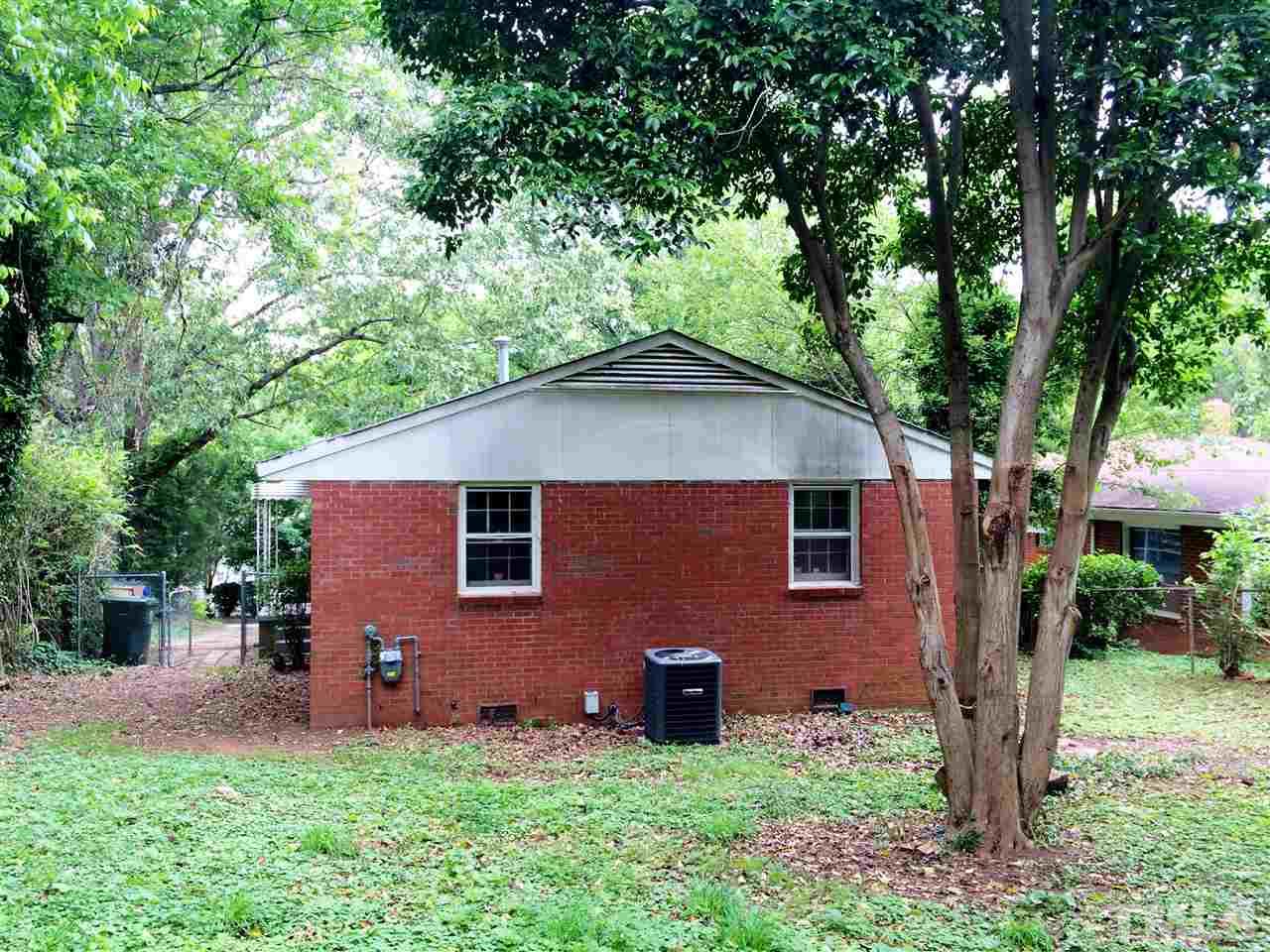 604 Latta Street Raleigh, NC 27607 - Photo 6 of 7 a view of a yard in front of a house with large windows