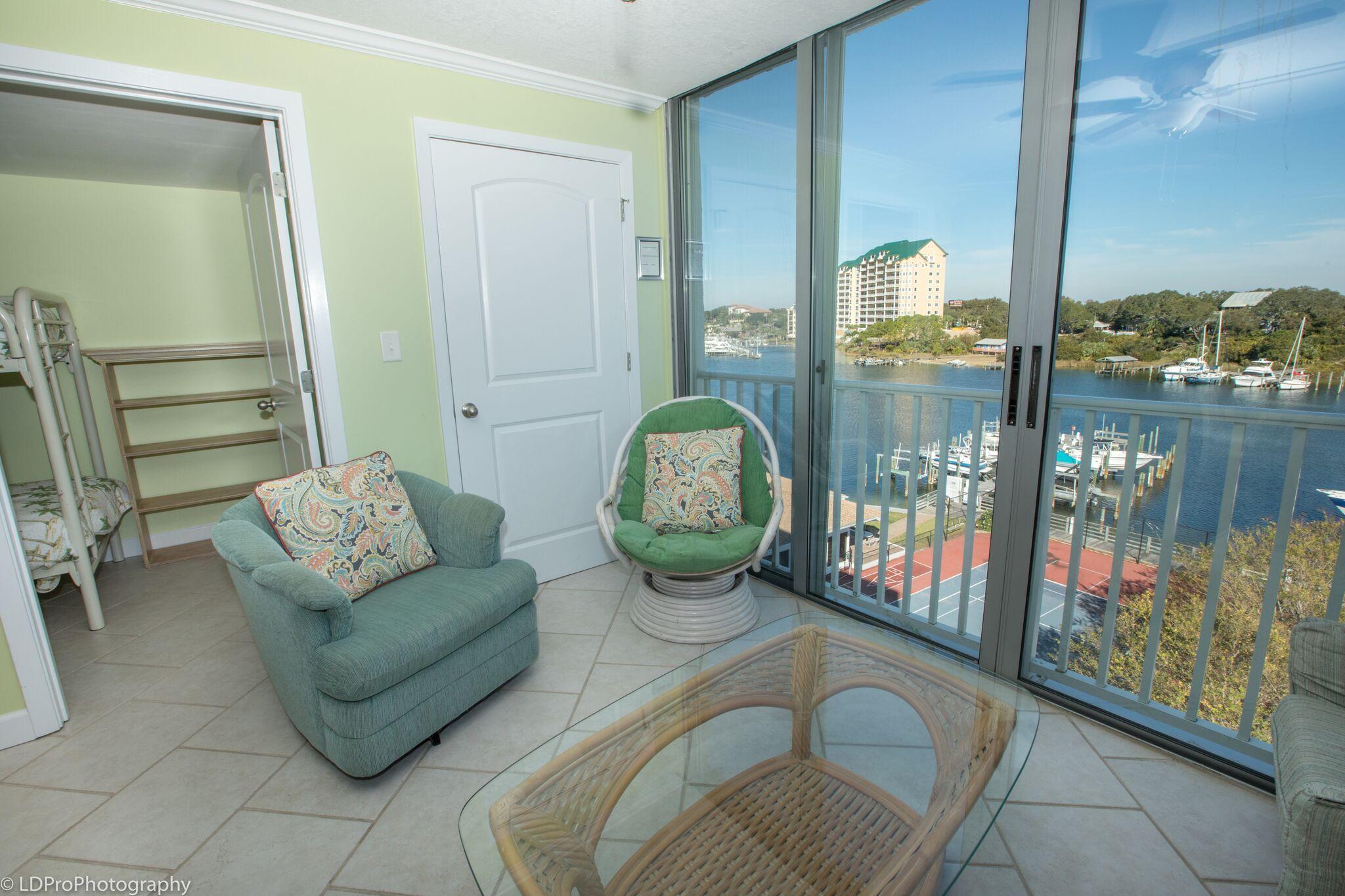 30 Moreno Point Road, Unit 601A Destin, FL 32541 - Photo 11 of 32 a living room with patio furniture and a floor to ceiling window