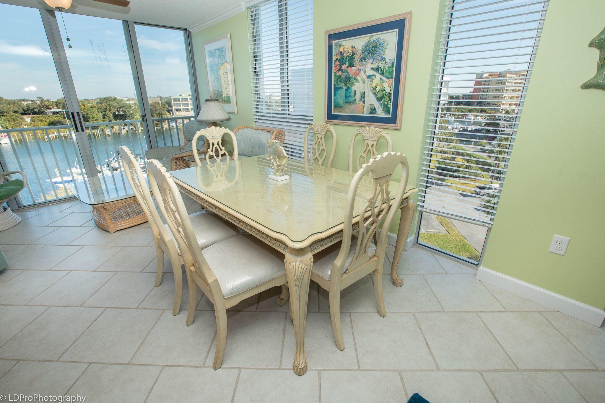 30 Moreno Point Road, Unit 601A Destin, FL 32541 - Photo 13 of 32 a dining room with furniture and a floor to ceiling window