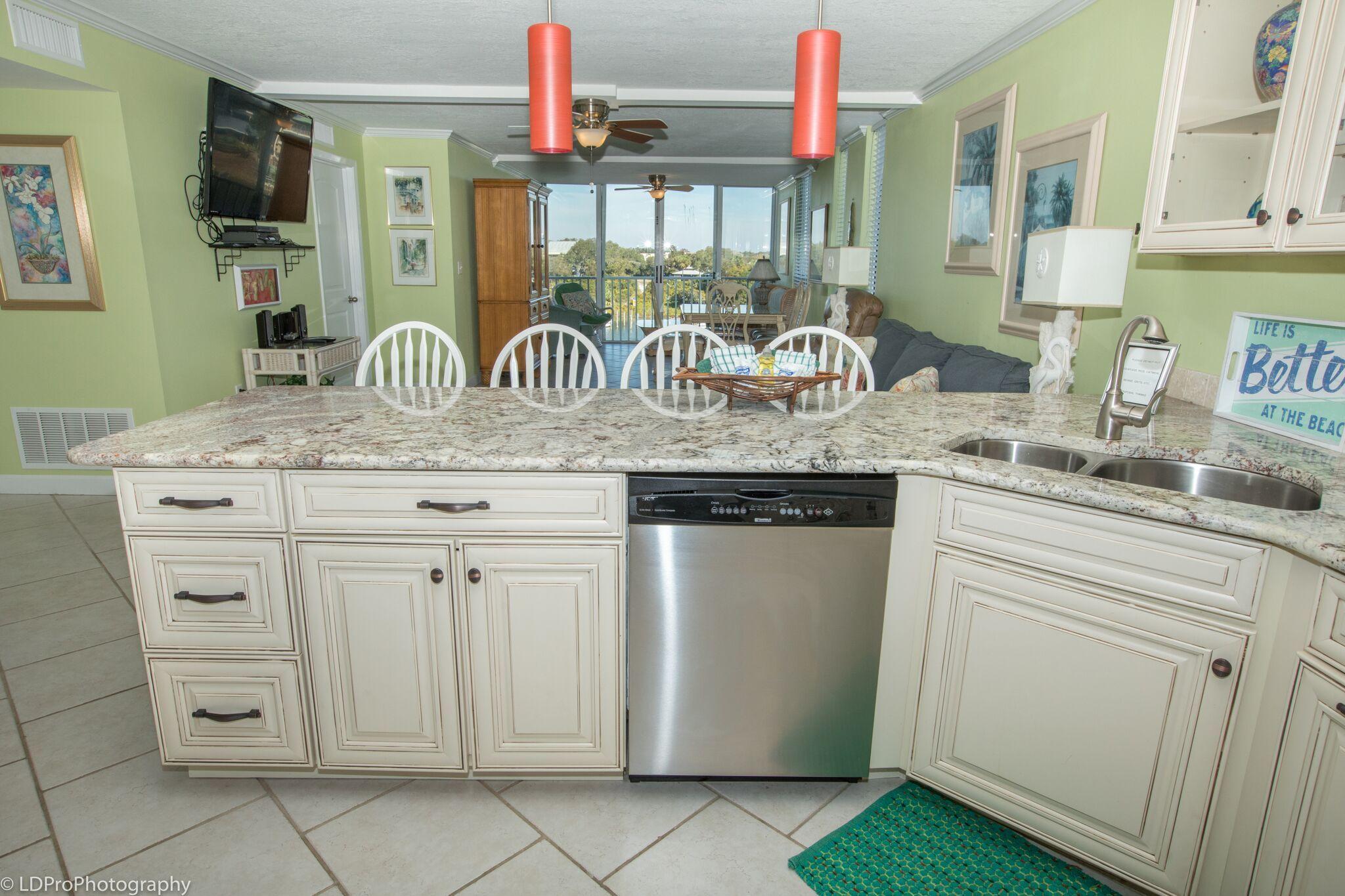 30 Moreno Point Road, Unit 601A Destin, FL 32541 - Photo 16 of 32 a kitchen with stainless steel appliances granite countertop a sink and a stove