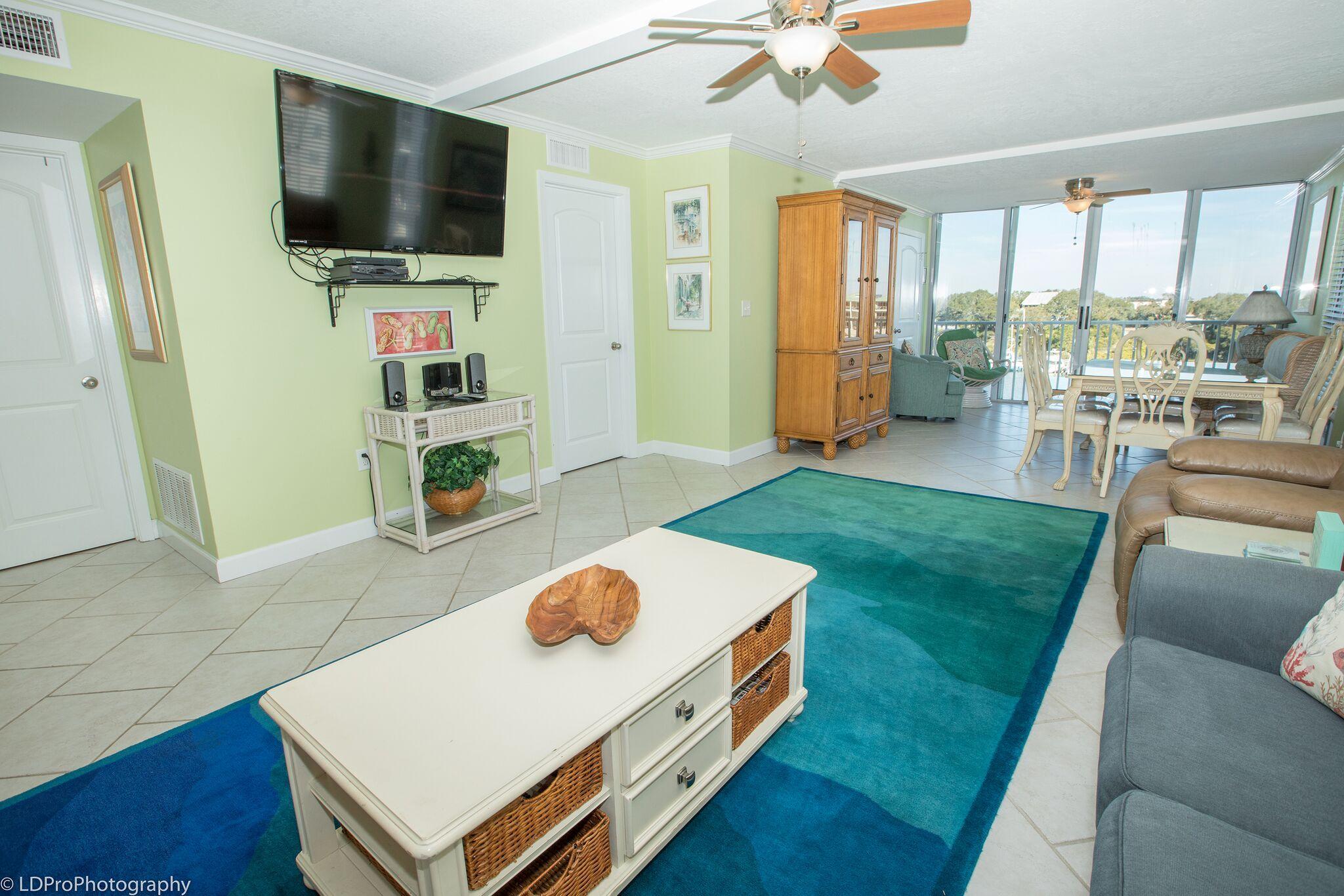 30 Moreno Point Road, Unit 601A Destin, FL 32541 - Photo 17 of 32 a living room with furniture and a flat screen tv