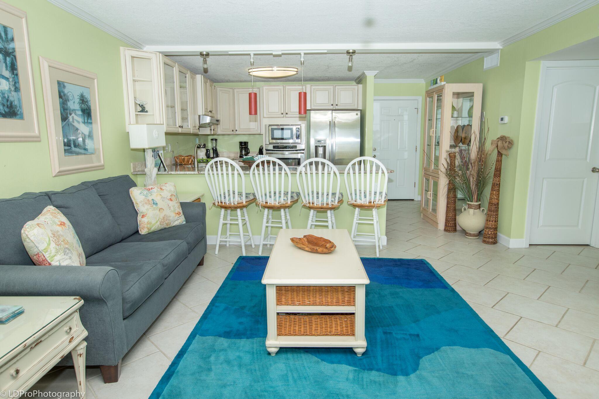 30 Moreno Point Road, Unit 601A Destin, FL 32541 - Photo 18 of 32 a living room with furniture and a table