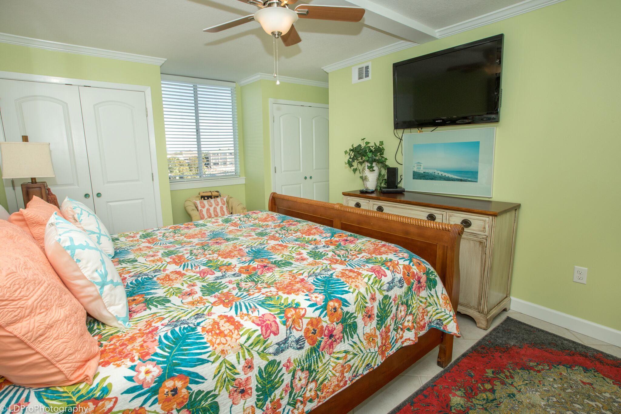 30 Moreno Point Road, Unit 601A Destin, FL 32541 - Photo 21 of 32 a bedroom with a bed and a flat screen tv