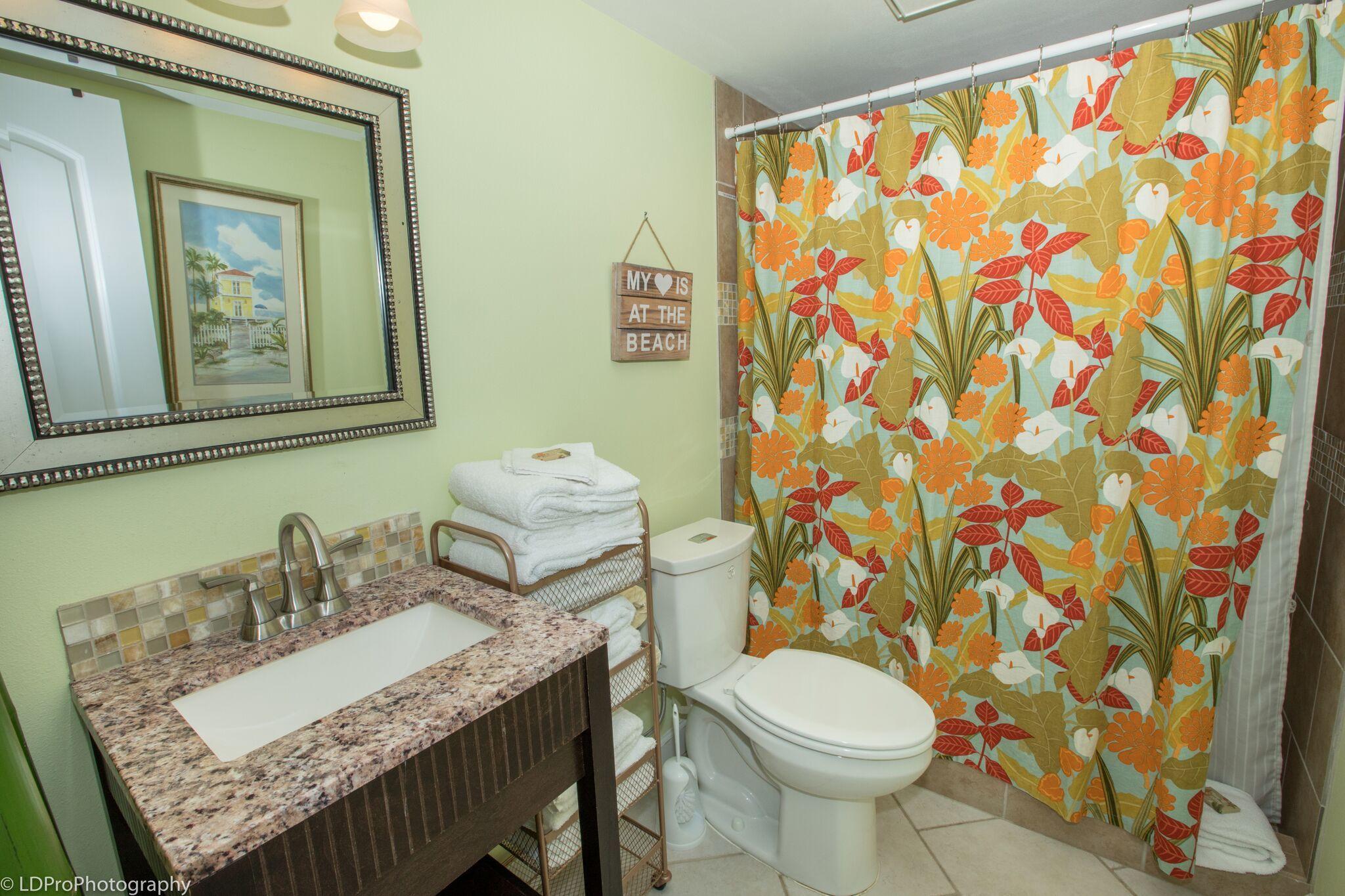 30 Moreno Point Road, Unit 601A Destin, FL 32541 - Photo 22 of 32 a white toilet sitting next to a bathroom sink