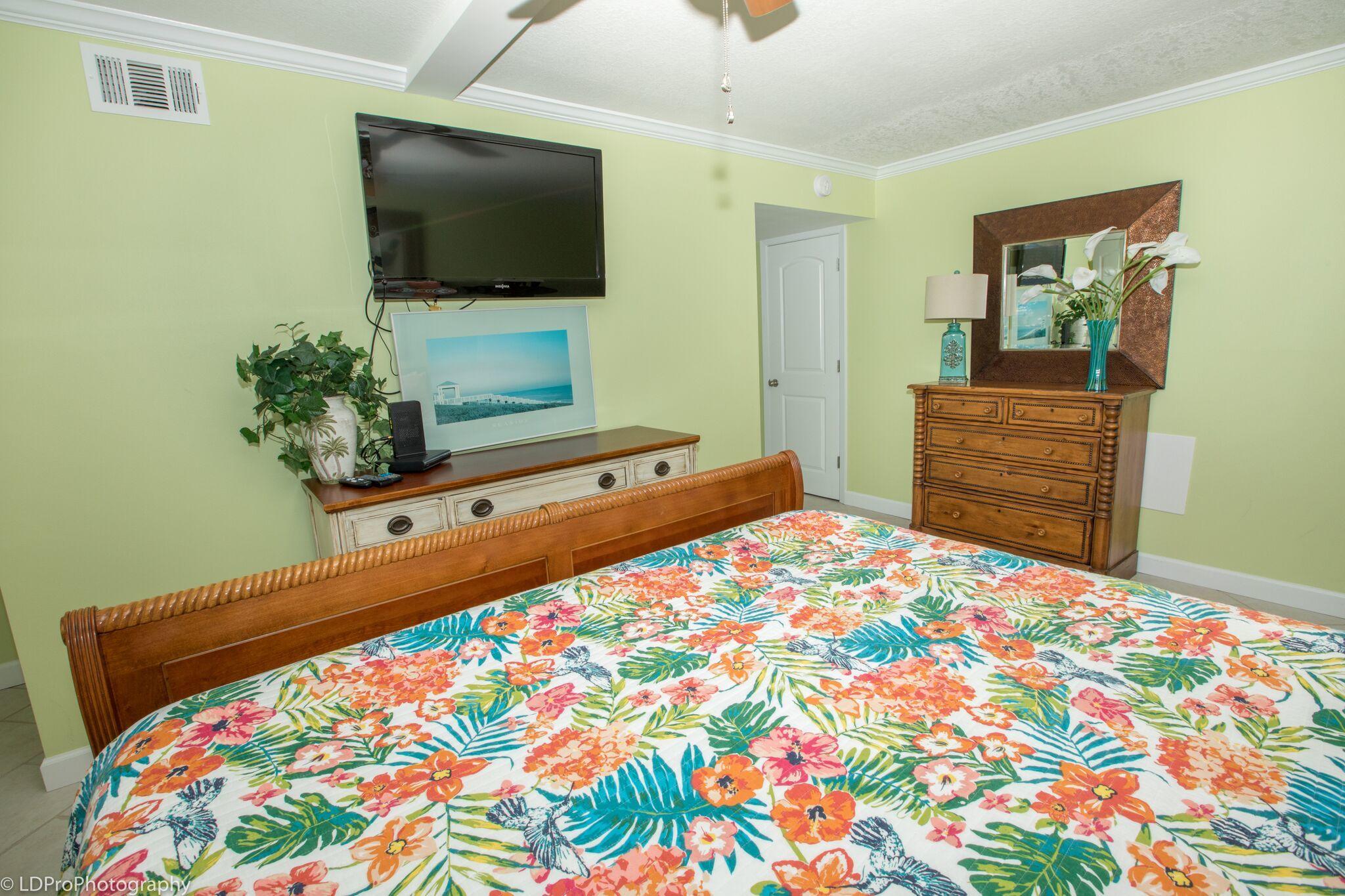 30 Moreno Point Road, Unit 601A Destin, FL 32541 - Photo 23 of 32 a bedroom with a bed and flat screen tv