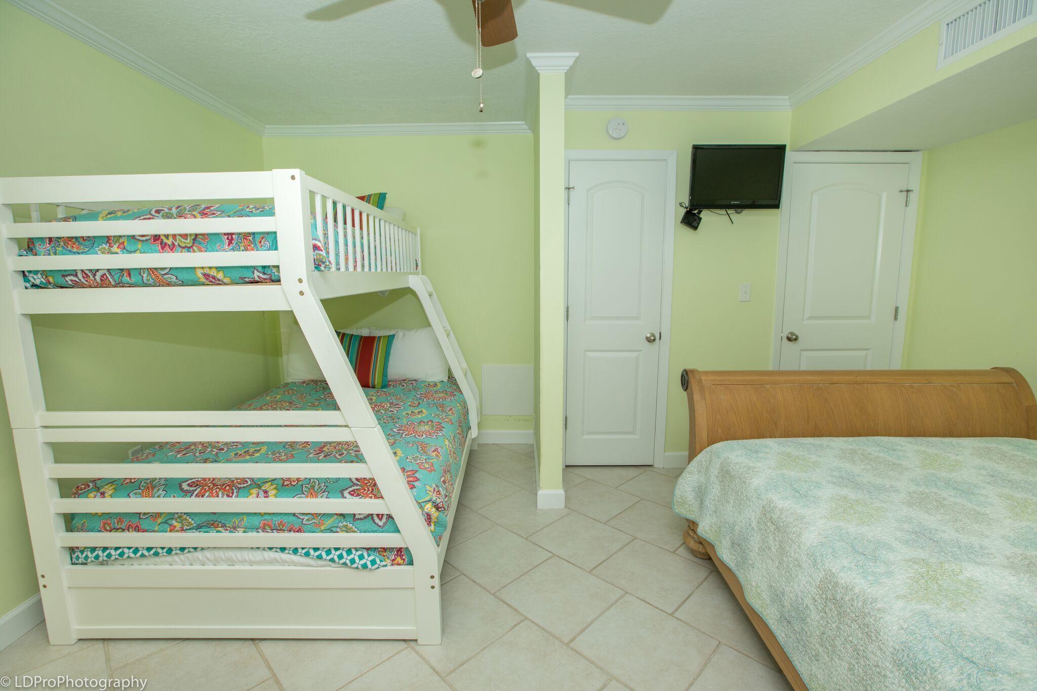 30 Moreno Point Road, Unit 601A Destin, FL 32541 - Photo 25 of 32 a bedroom with a bed and a flat screen tv