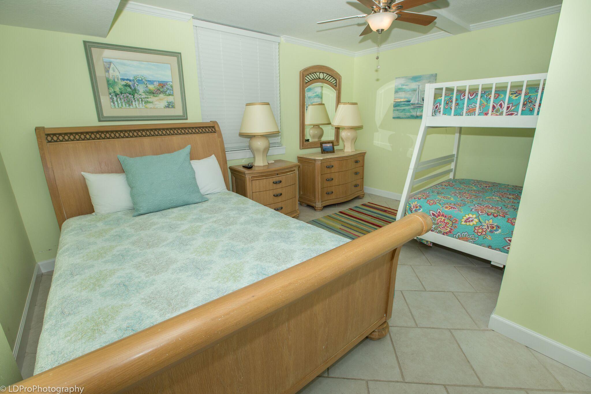 30 Moreno Point Road, Unit 601A Destin, FL 32541 - Photo 27 of 32 a bedroom with a bed and a book shelf