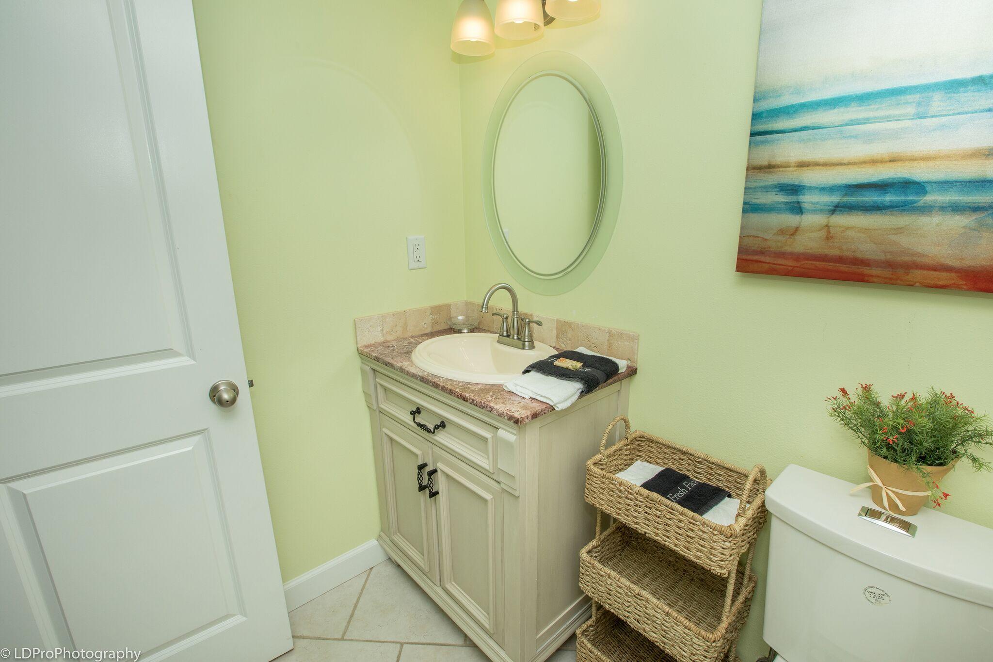 30 Moreno Point Road, Unit 601A Destin, FL 32541 - Photo 29 of 32 a bathroom with a sink mirror vanity and toilet