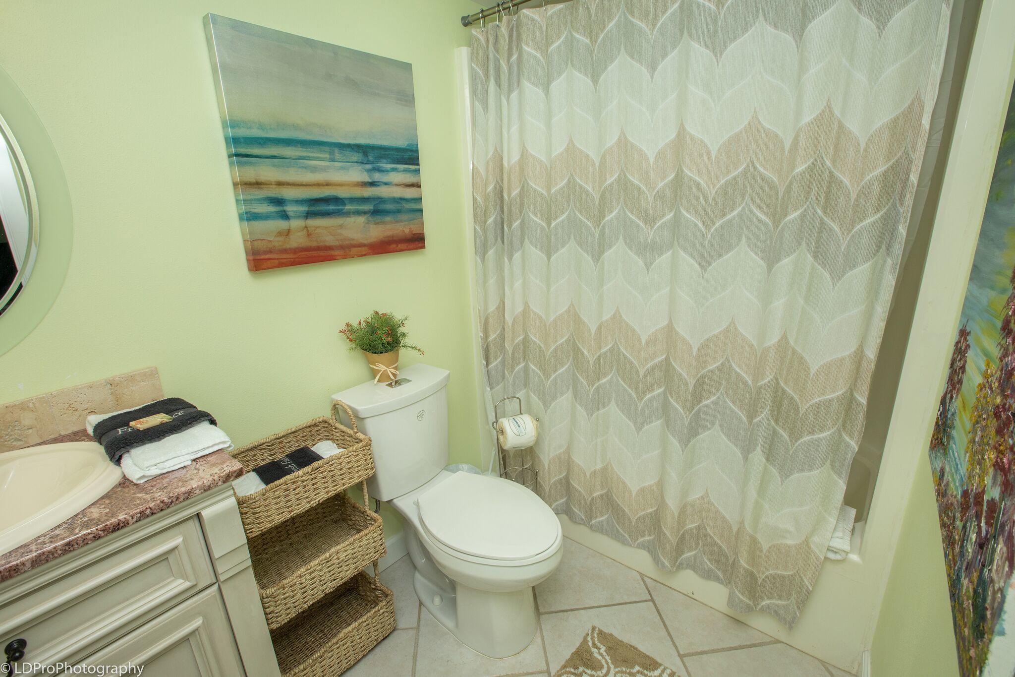 30 Moreno Point Road, Unit 601A Destin, FL 32541 - Photo 30 of 32 a white toilet sitting next to a shower curtain