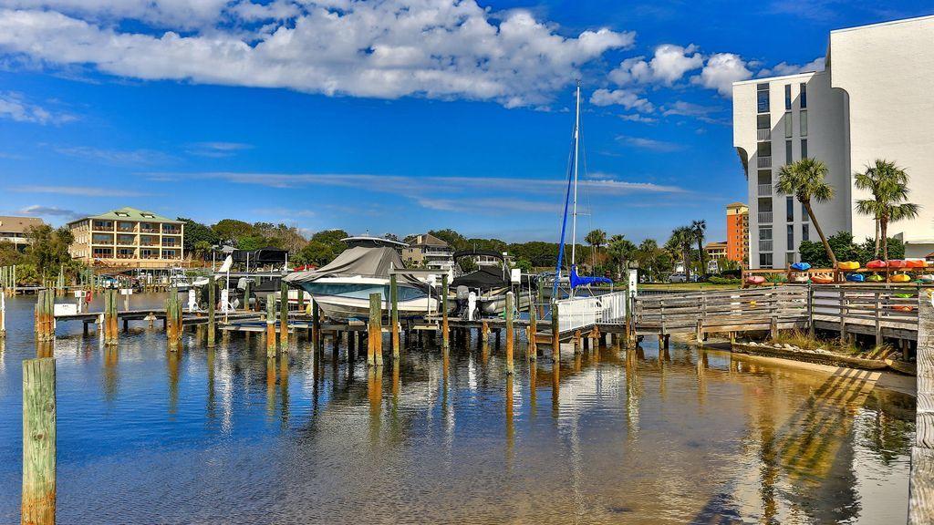 30 Moreno Point Road, Unit 601A Destin, FL 32541 - Photo 8 of 32 a view of a swimming pool with a table and chairs