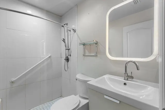 a bathroom with a sink toilet and shower
