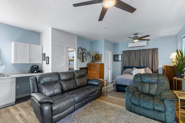 a bedroom with bed and wooden floor