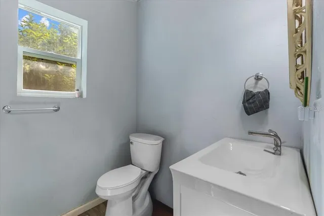 a view of large house with a yard and potted plants