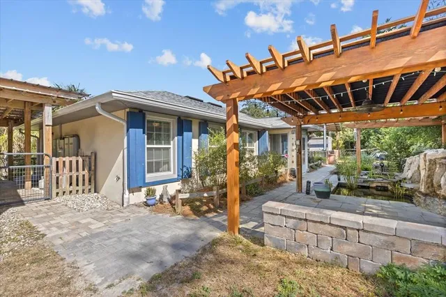 an aerial view of residential houses with outdoor space and trees