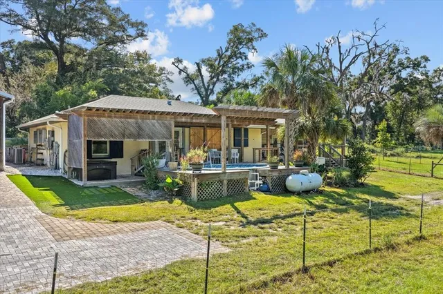a front view of a house with a yard glass top table and chairs