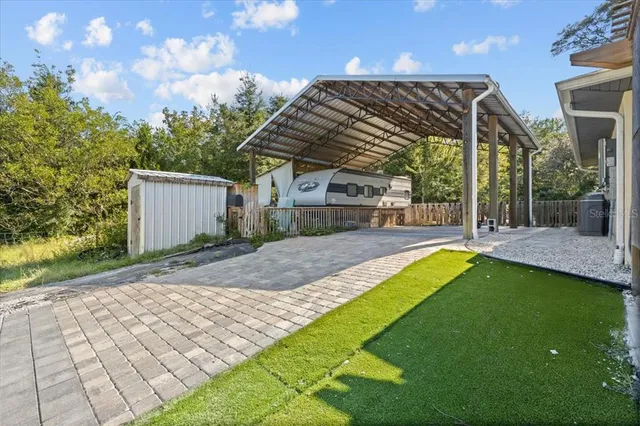 a view of a house with a backyard and a patio