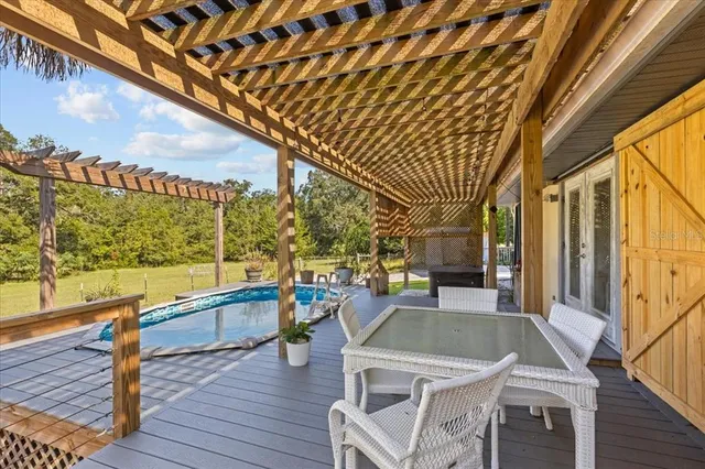 a kitchen with stainless steel appliances granite countertop table chairs and wooden floor