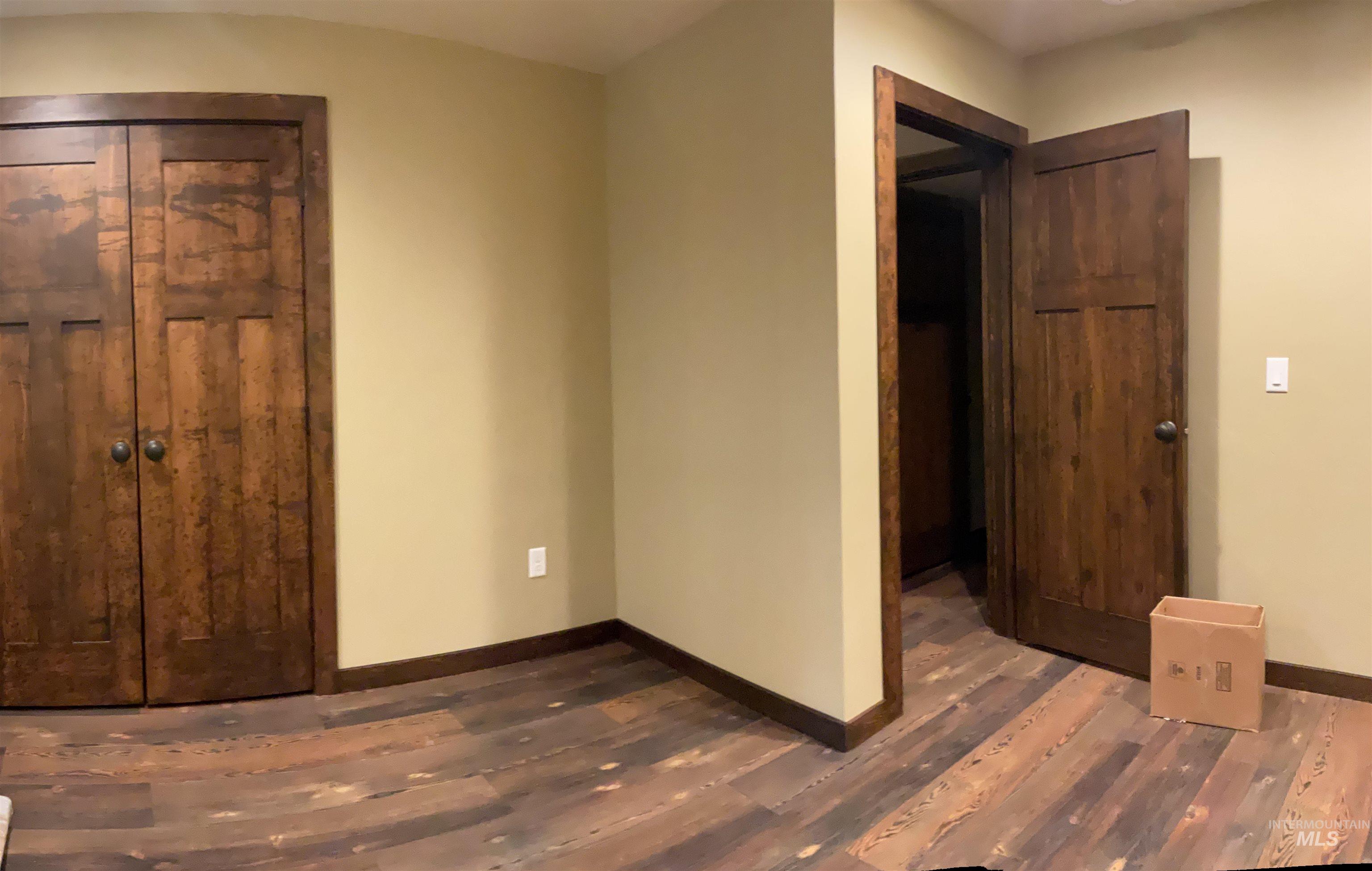 6125 Freeman Creek Road Lenore, ID 83541 - Photo 38 of 44 Dedicated utility area featuring a stainless steel sink with a gooseneck faucet, light neutral wall paint, and a dark wood-finish door
