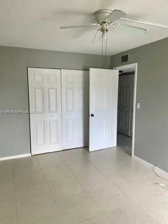 a bathroom with a granite countertop sink mirror toilet and shower