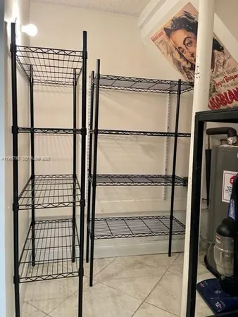 a view of a hallway with wooden floor and a bathroom