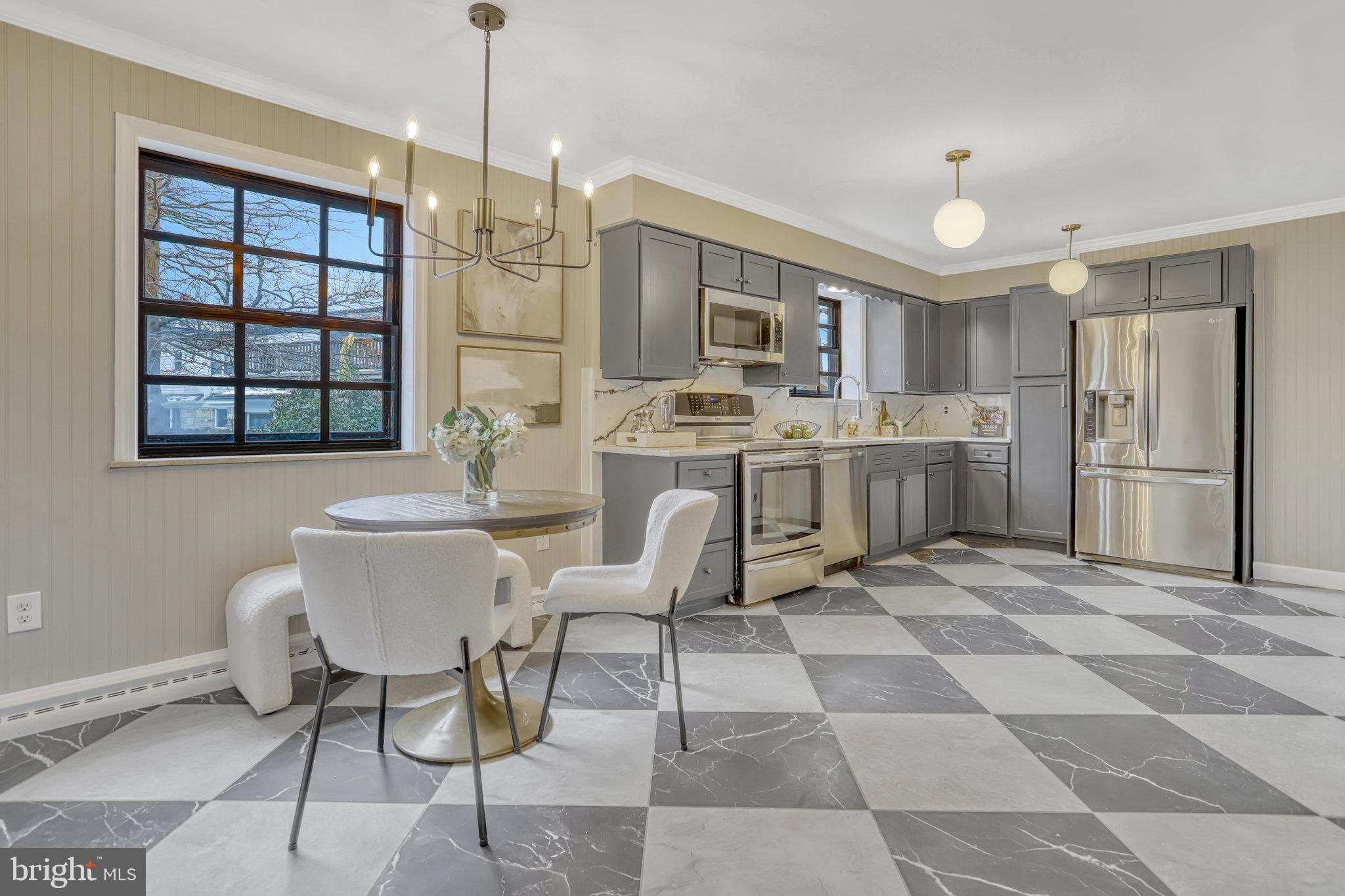 826 West Braddock Road Alexandria, VA 22302 - Photo 13 of 56 a kitchen with stainless steel appliances granite countertop a stove a refrigerator a sink a dining table and chairs with wooden floor