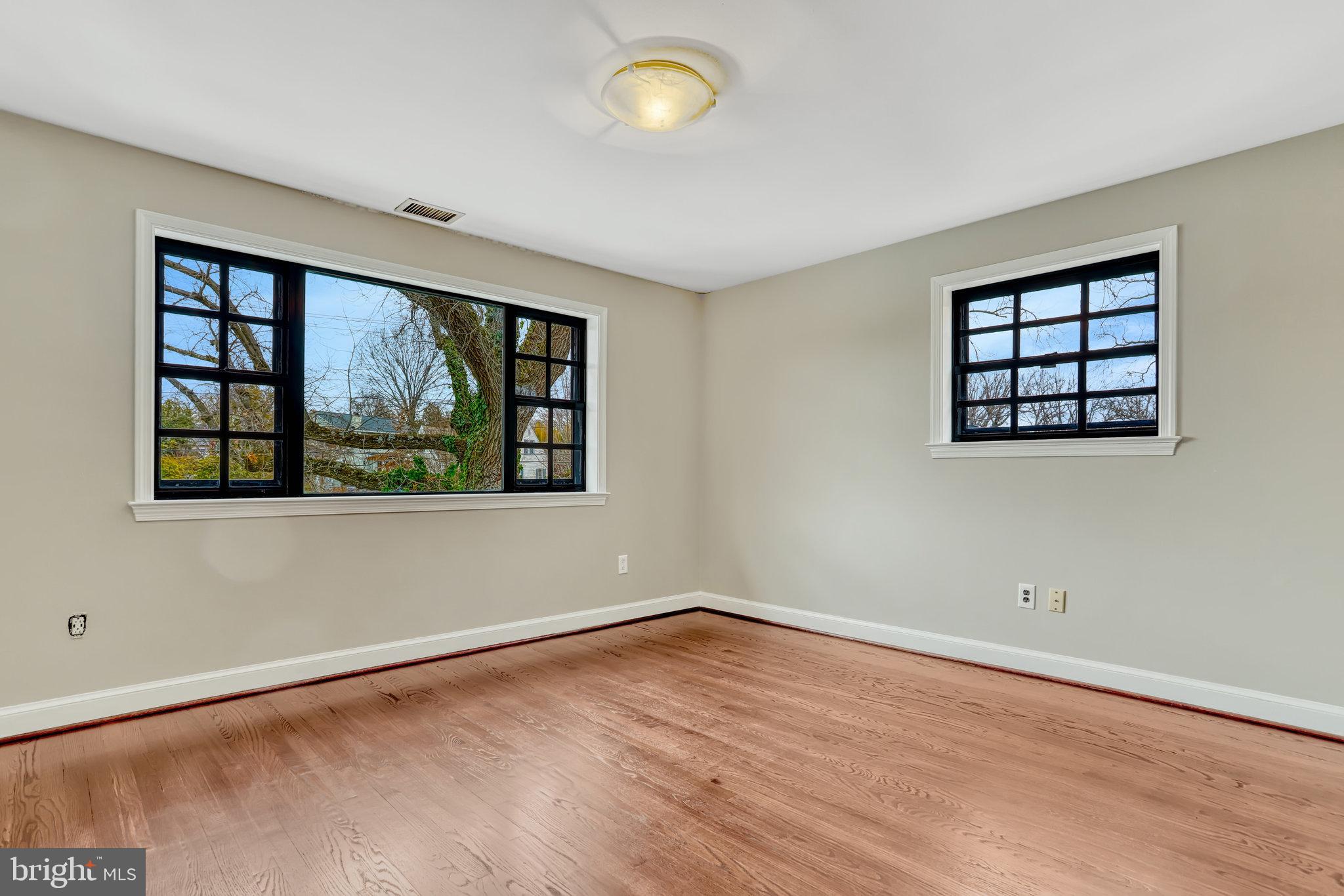 826 West Braddock Road Alexandria, VA 22302 - Photo 38 of 56 an empty room with wooden floor and windows