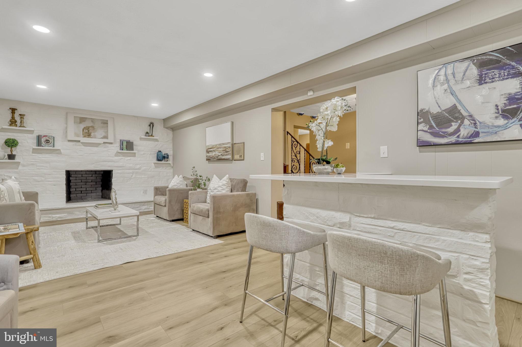 826 West Braddock Road Alexandria, VA 22302 - Photo 50 of 56 a living room with furniture a fireplace and a flat screen tv