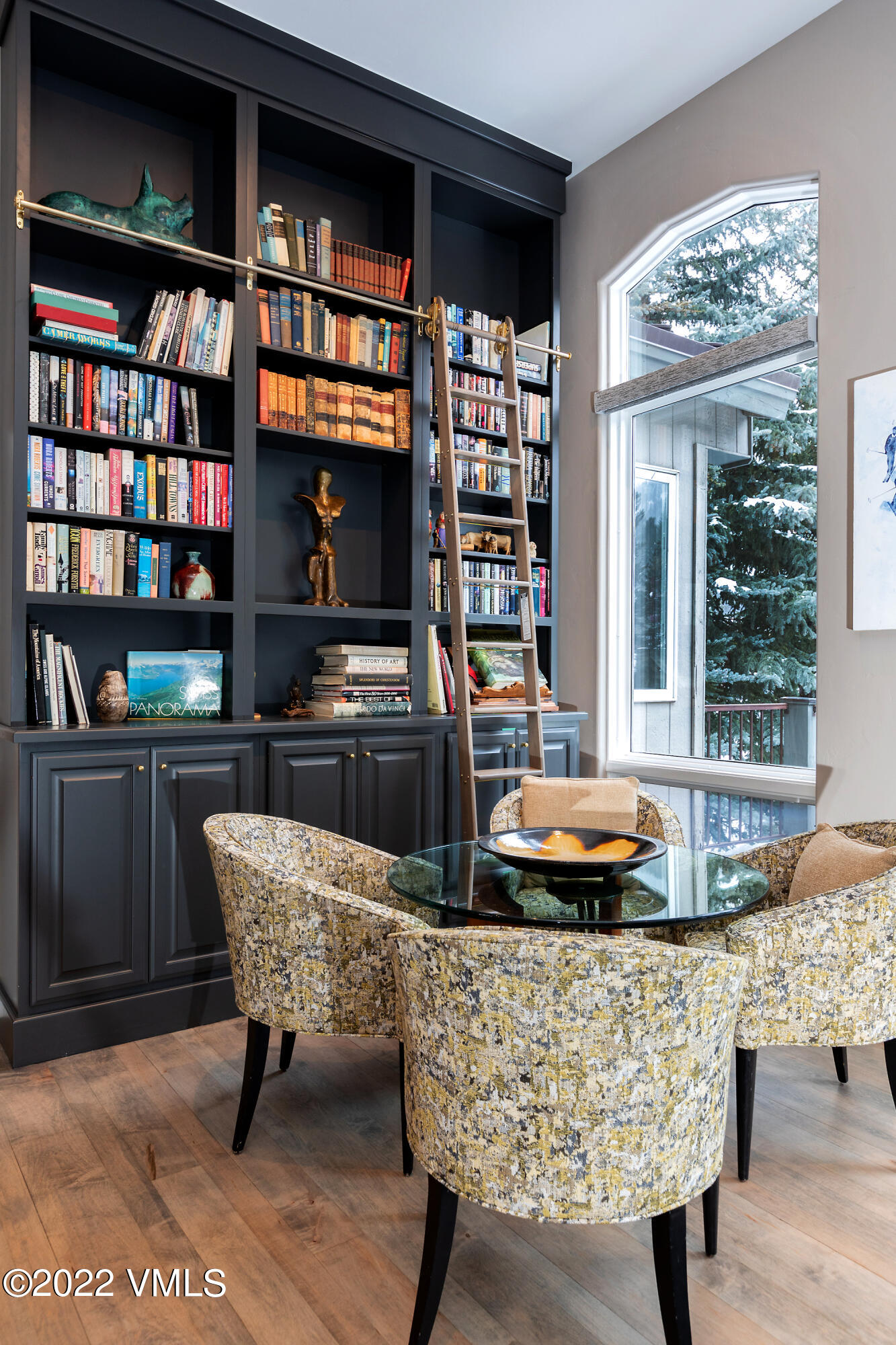 1850 South Frontage Road West, Unit 3 Vail, CO 81657 - Photo 4 of 28 a dining room with a large window and a book shelf