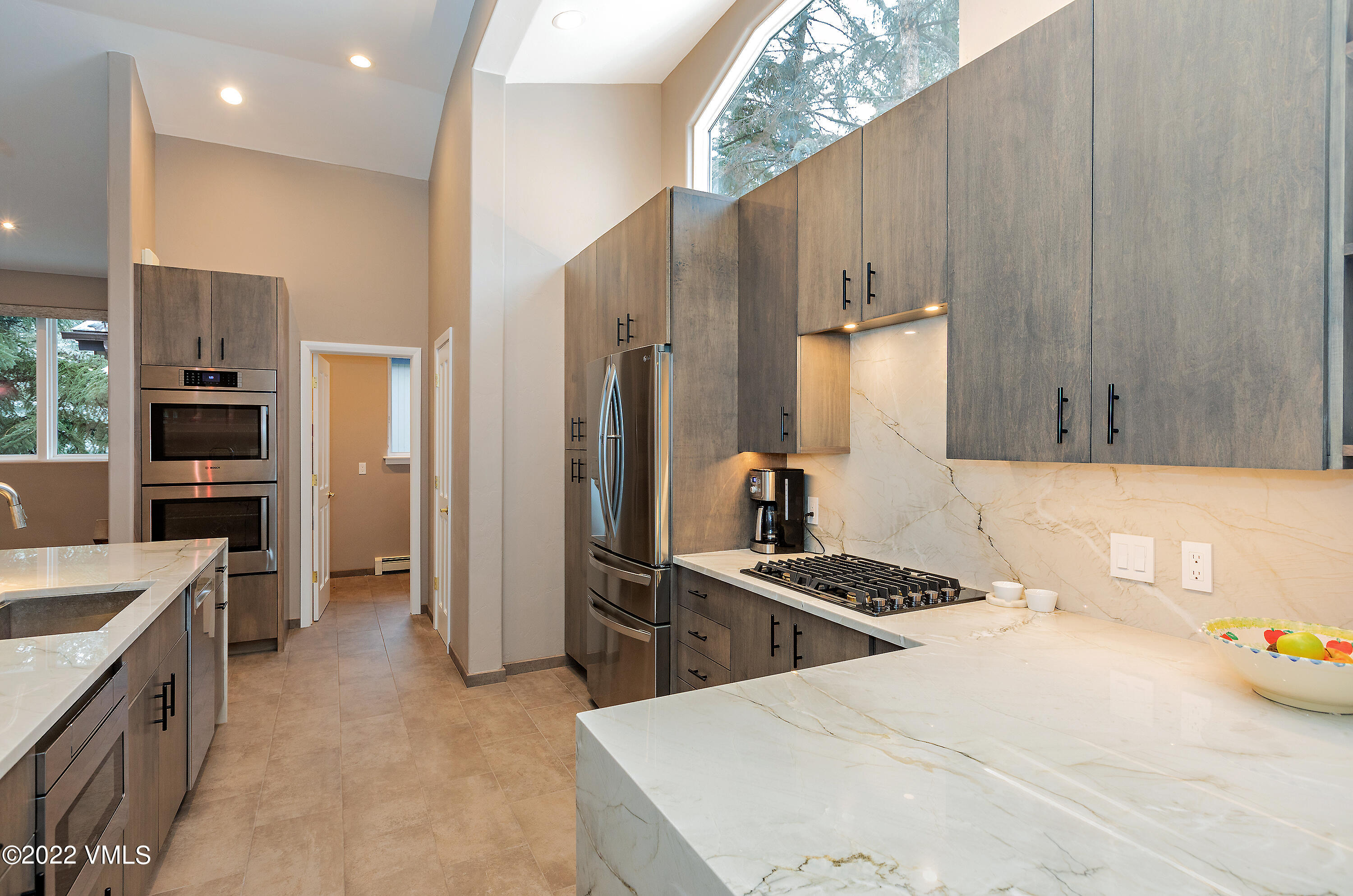 1850 South Frontage Road West, Unit 3 Vail, CO 81657 - Photo 6 of 28 a kitchen with stainless steel appliances a refrigerator sink and stove