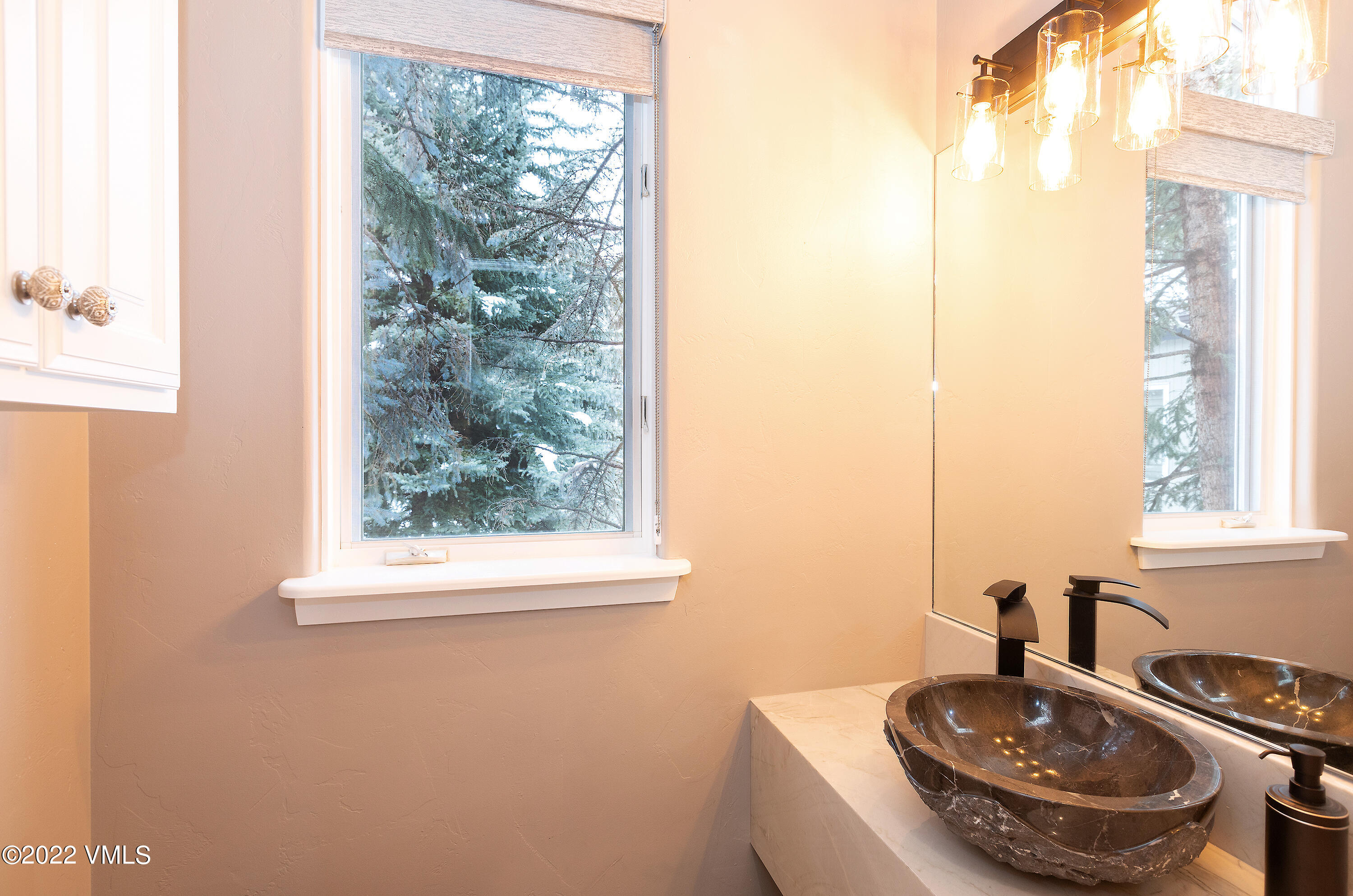 1850 South Frontage Road West, Unit 3 Vail, CO 81657 - Photo 9 of 28 a bathroom with a sink and a mirror