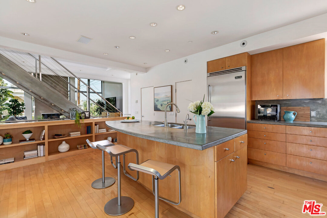 32 Fleet Street Marina del Rey, CA 90292 - Photo 12 of 39 a kitchen with stainless steel appliances granite countertop sink stove and cabinets