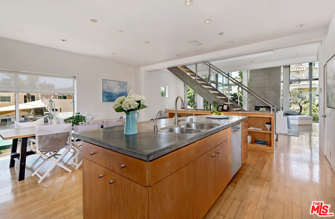 32 Fleet Street Marina del Rey, CA 90292 - Photo 13 of 39 a kitchen with stainless steel appliances granite countertop a sink counter space and wooden floor