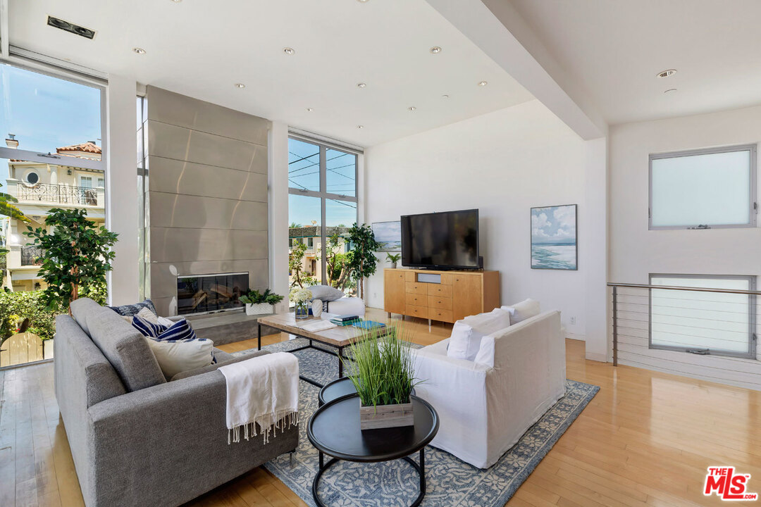 32 Fleet Street Marina del Rey, CA 90292 - Photo 3 of 39 a living room with furniture a flat screen tv and a fireplace