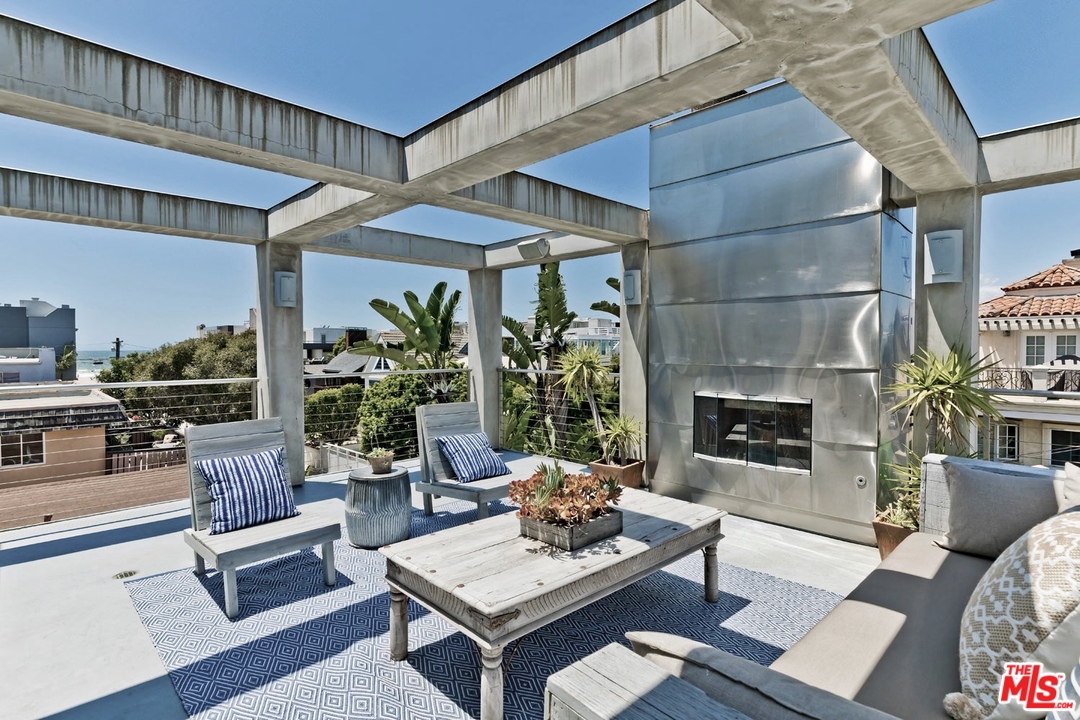 32 Fleet Street Marina del Rey, CA 90292 - Photo 22 of 39 a living room with furniture a fireplace and potted plants