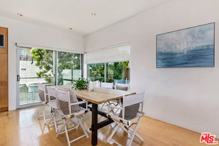32 Fleet Street Marina del Rey, CA 90292 - Photo 31 of 39 a view of a dining room with furniture large windows and wooden floor