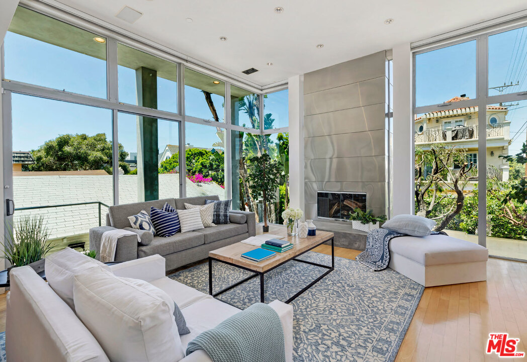 32 Fleet Street Marina del Rey, CA 90292 - Photo 5 of 39 a living room with furniture fireplace and a large window