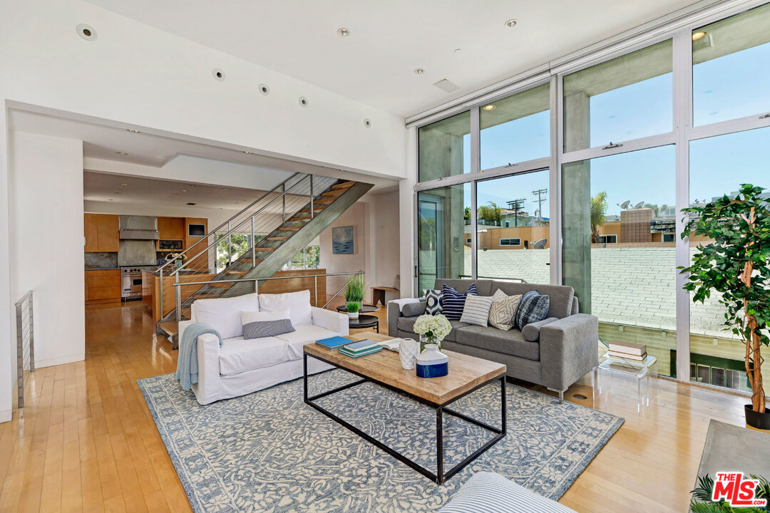 32 Fleet Street Marina del Rey, CA 90292 - Photo 6 of 39 a living room with furniture a rug and a large window