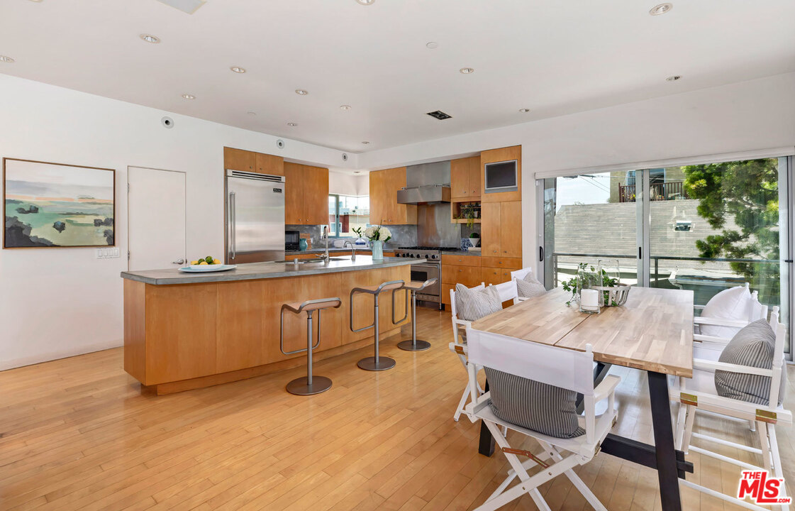 32 Fleet Street Marina del Rey, CA 90292 - Photo 9 of 39 a room with stainless steel appliances kitchen island granite countertop furniture and a dining table