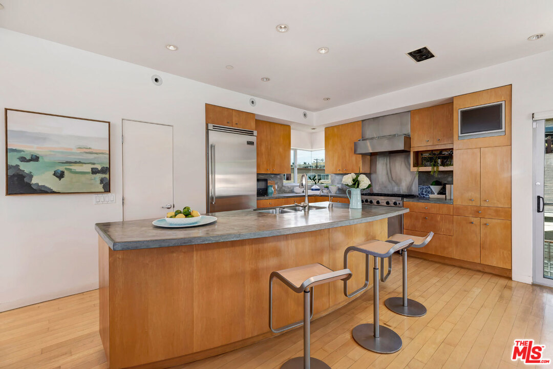 32 Fleet Street Marina del Rey, CA 90292 - Photo 10 of 39 a kitchen with stainless steel appliances granite countertop a sink and a refrigerator