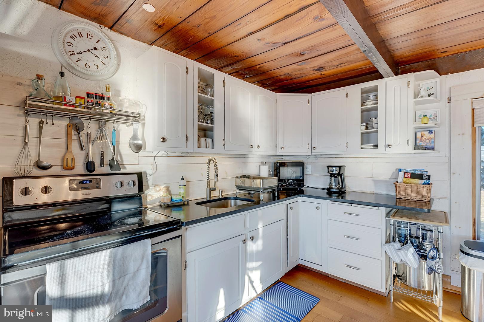 7950 Riverview Road Westover, MD 21871 - Photo 11 of 57 a kitchen with stainless steel appliances a sink a stove and cabinets