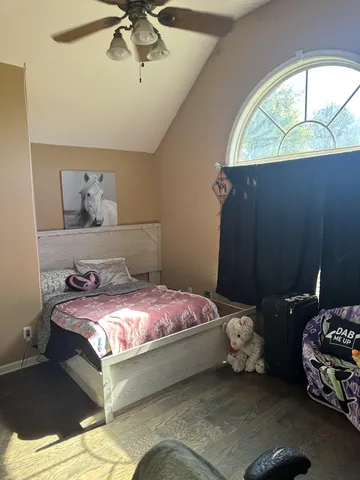 a bedroom with a bed and window