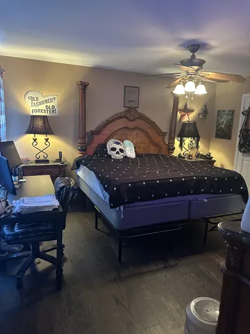 a bed room with a bed and a chandelier