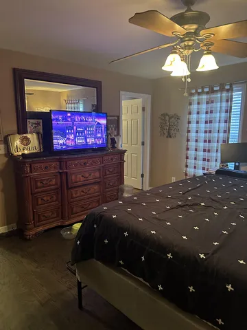 a bedroom with a bed and a chandelier