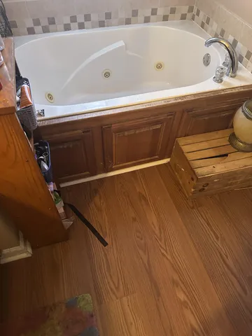 a bathroom with a tub and a sink