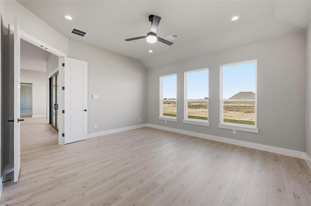 108 Rocky Top Azle, TX 76020 - Photo 21 of 40 an empty room with wooden floor and windows