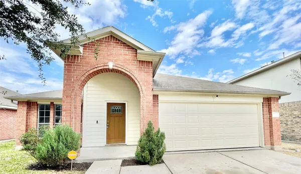 a view of a house with a door and a tree