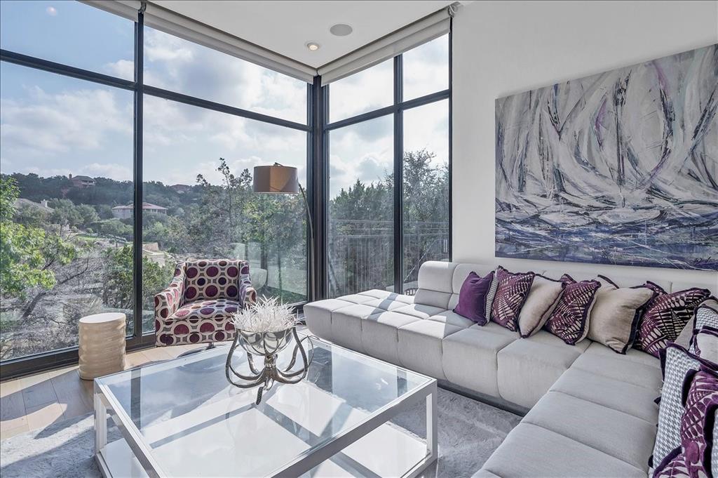 Living room featuring floor to ceiling windows and wood finished floors