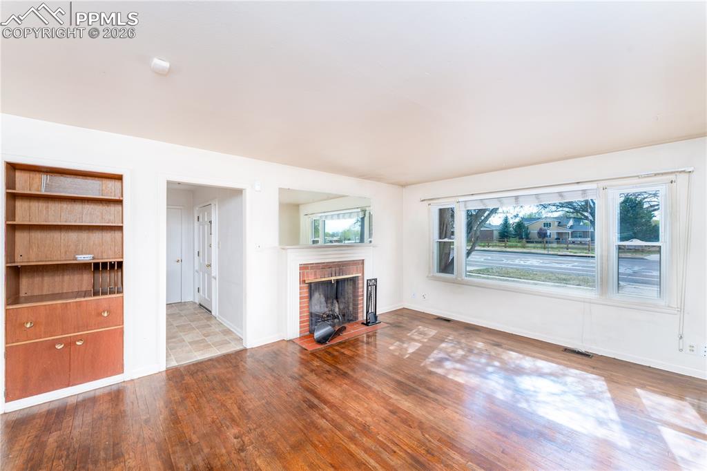 2818 Templeton Gap Road Colorado Springs, CO 80907 - Photo 3 of 27 a view of an empty room with a window and fireplace