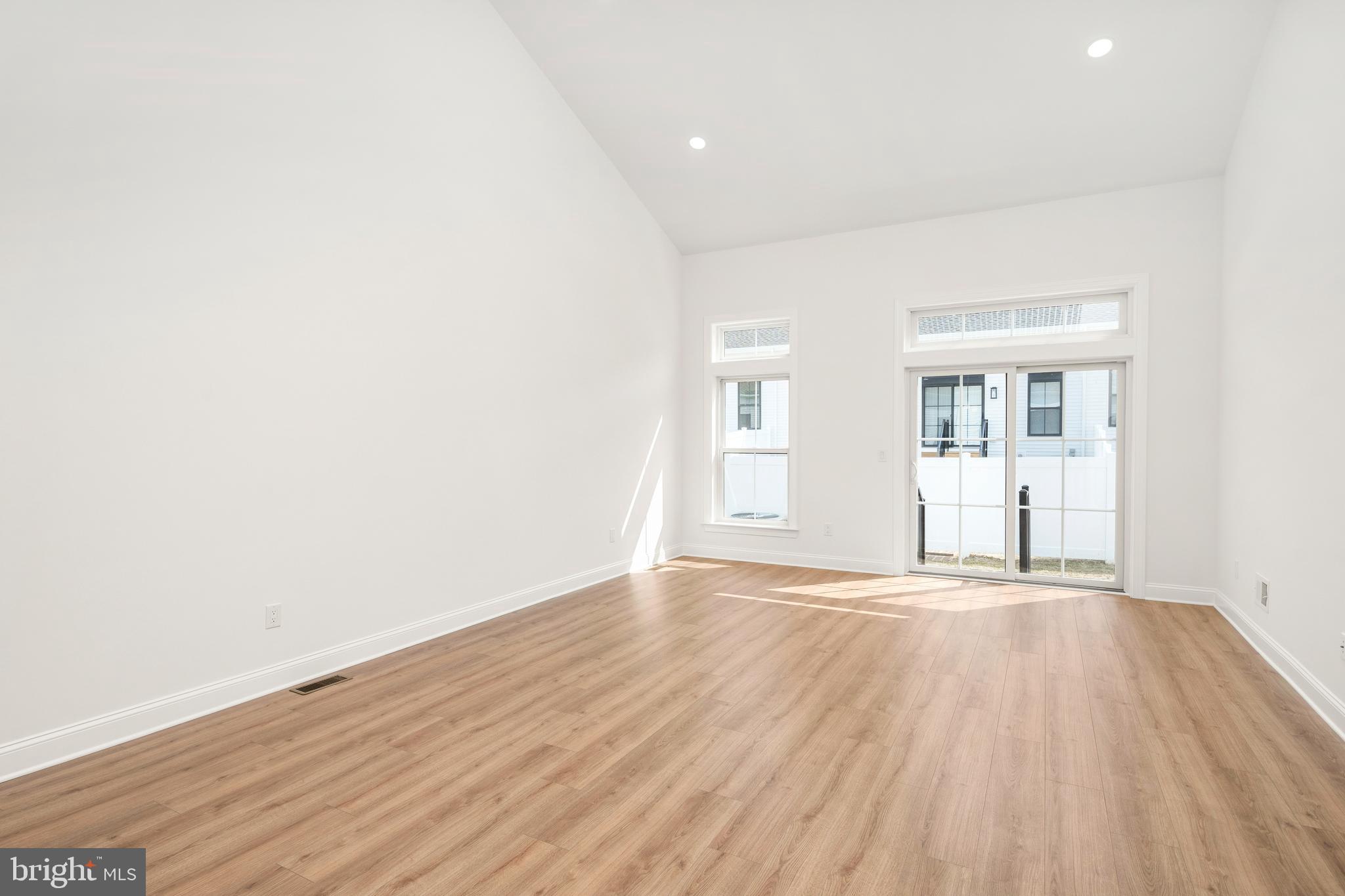55 Kay Chiarello Way Hamilton, NJ 08690 - Photo 5 of 49 an empty room with wooden floor and windows